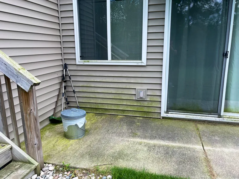 Before: patio, siding and sliding door with green algae and dirt in Zeeland