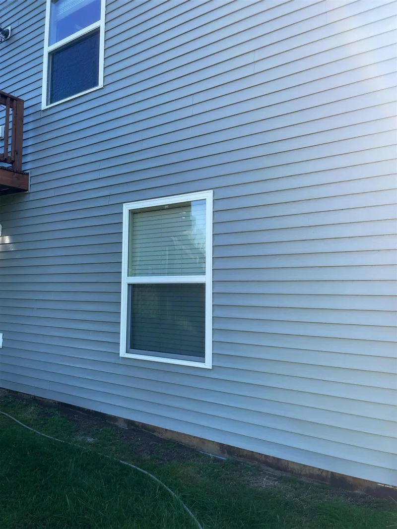 After: the grey siding clean and uniform